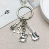 Vintage Silver Band Keychain: Guitar, Microphone, Musical Note & Drum Pendant