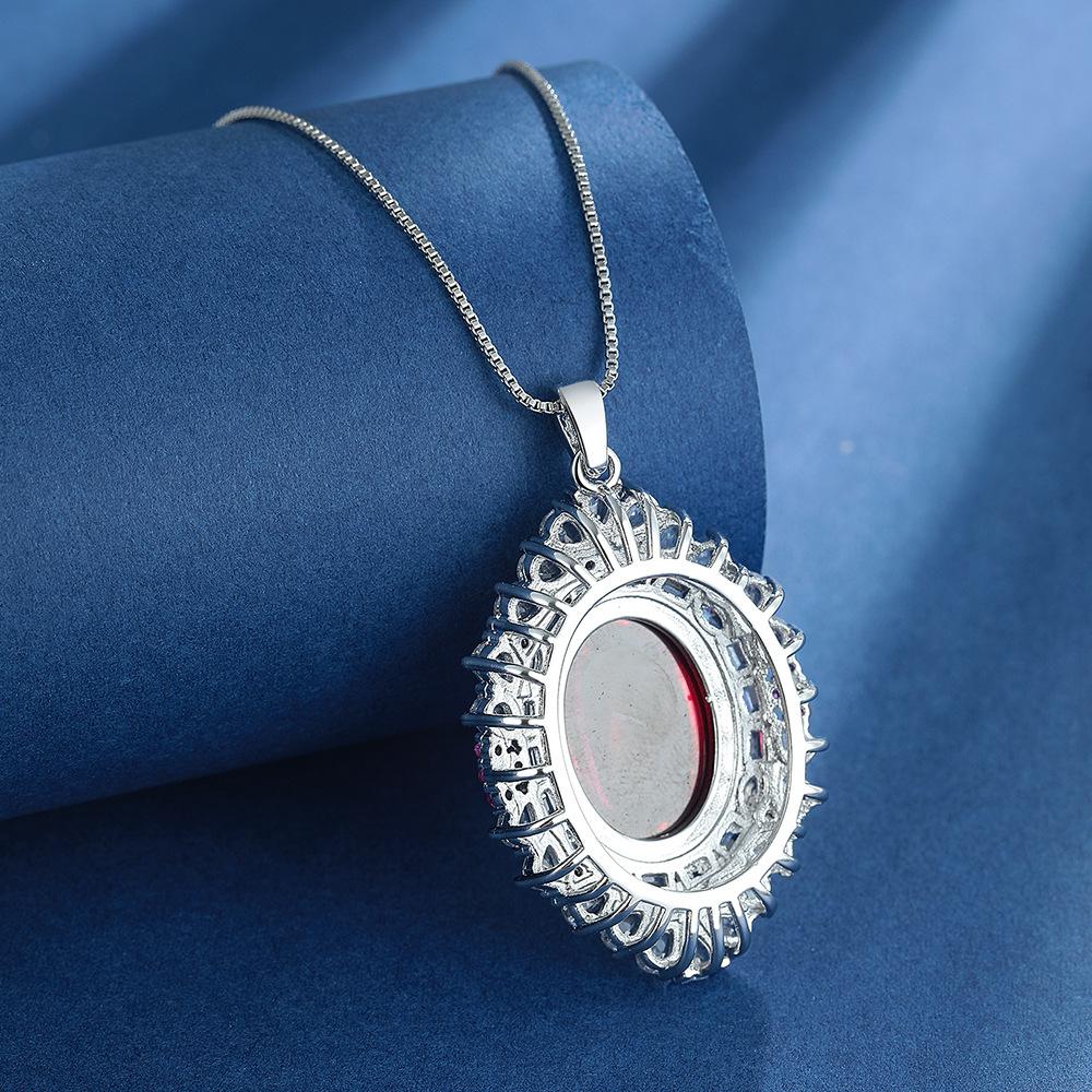 Retro Simulation Colored Treasure Egg-Shaped Hollow Red Steel Jade Inlaid Zircon Pendant