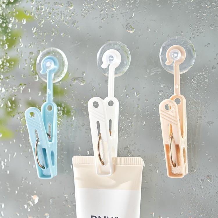 Пластиковые зажимы на присосках с крючками для организации хранения на кухне и дома.