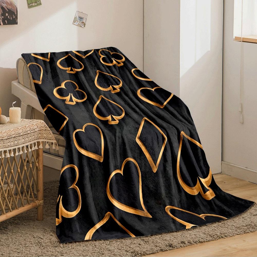Golden outlines of card suits on a textured black background. for all seasons blanket lunch break throw gift