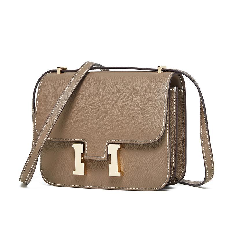 "2024 Кожаная сумка через плечо Kangkang с пряжкой H-образной формы: Модная, натуральная коровья кожа, универсальный дизайн на одно плечо.