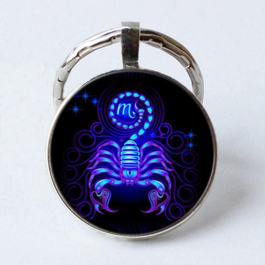 Металлический брелок с драгоценными камнями и символами зодиака