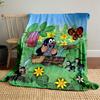 A cheerful mole bathes in a wooden tub among vibrant nature and insects. for all seasons blanket lunch break throw gift
