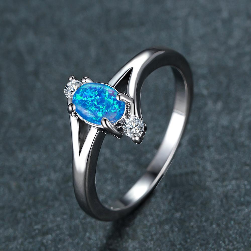 New blue opal oval platinum four-claw blue opal edge white diamond, design sense ocean wind