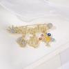 Blue-Eyed Palm Crown Letter Zircon Brooch Fashionable Personalized Retro God's Eye Design New Wholesale Brooch