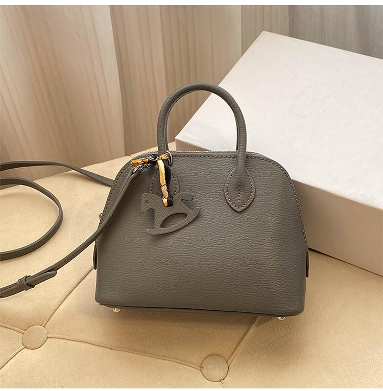 Премиальная мини-сумка-ракушка для женщин 2025 года, новая модная иностранная стильная изысканная сумка для переноски на одно плечо, диагональный пролет, воловья кожа, маленькая