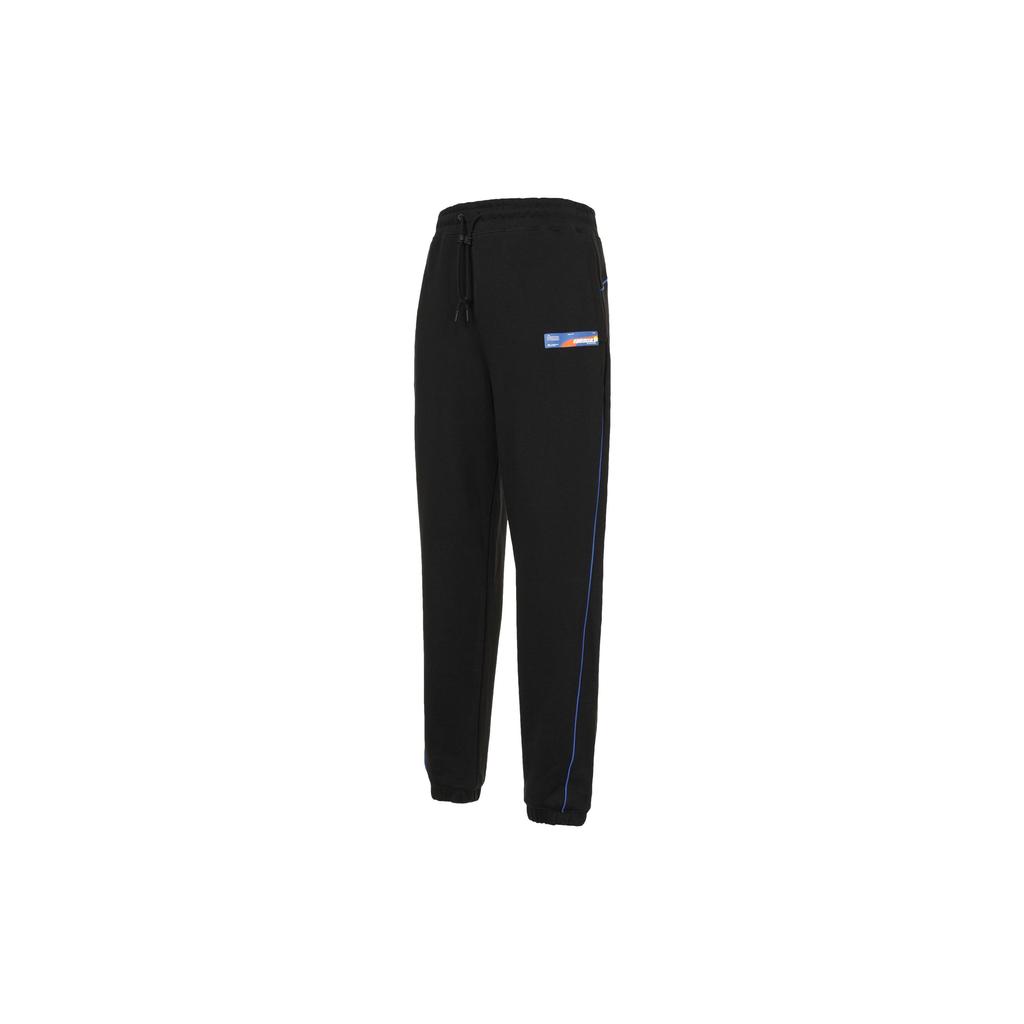 Puma Совместные спортивные штаны X Roaringwild с контрастными карманами на молнии и нашивкой с логотипом на трикотажных манжетах Мужские брюки черные 532595-01