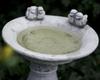 Concrete bird waterer on a column for the garden