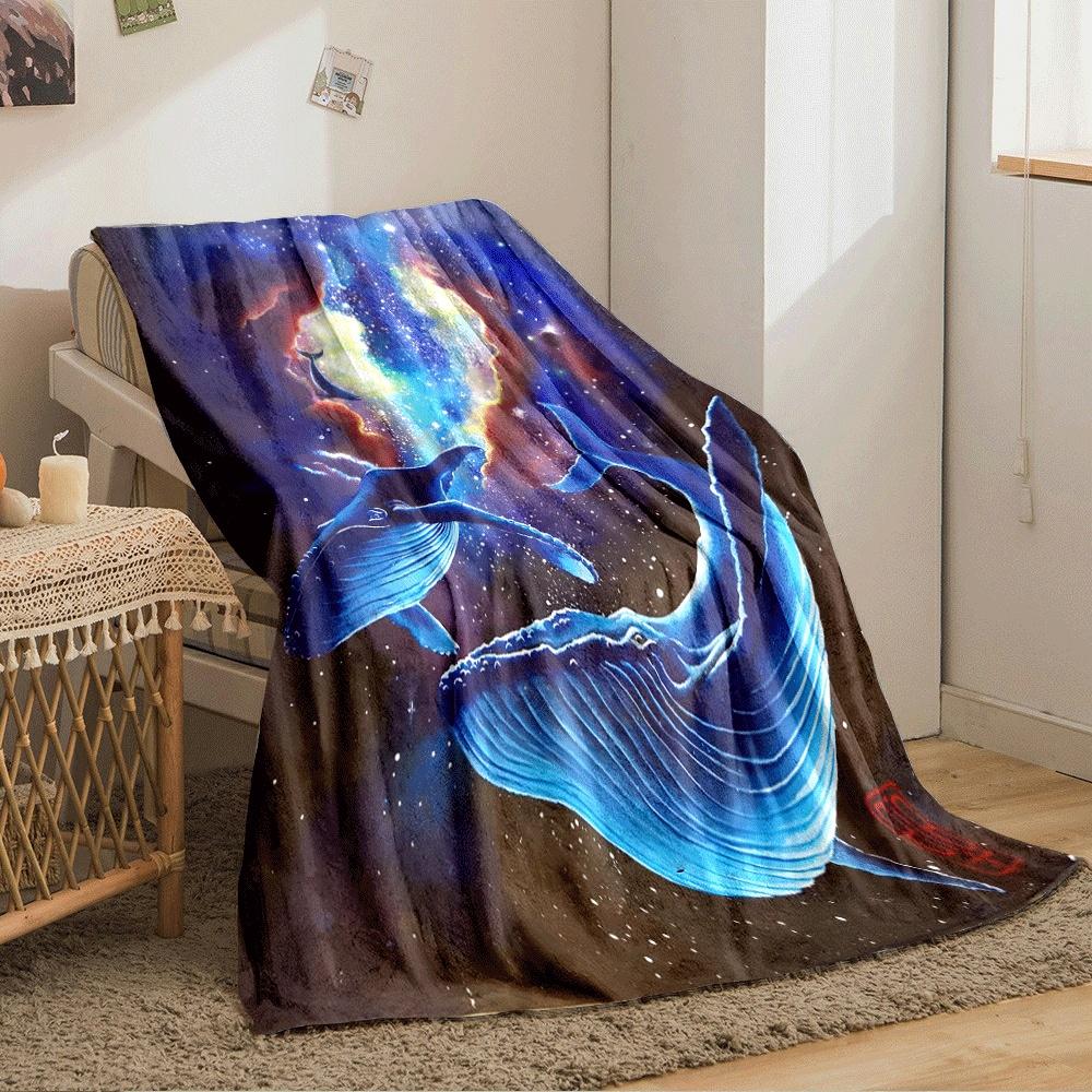 Glowing blue whales drift in a cosmic scene with vibrant nebulae and stars. for all seasons blanket lunch break throw gift