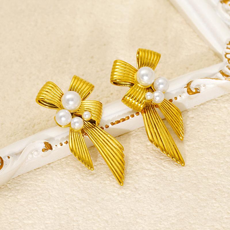 New stainless steel pearl bow earrings, a chic and unique design for women, with a European and American style
