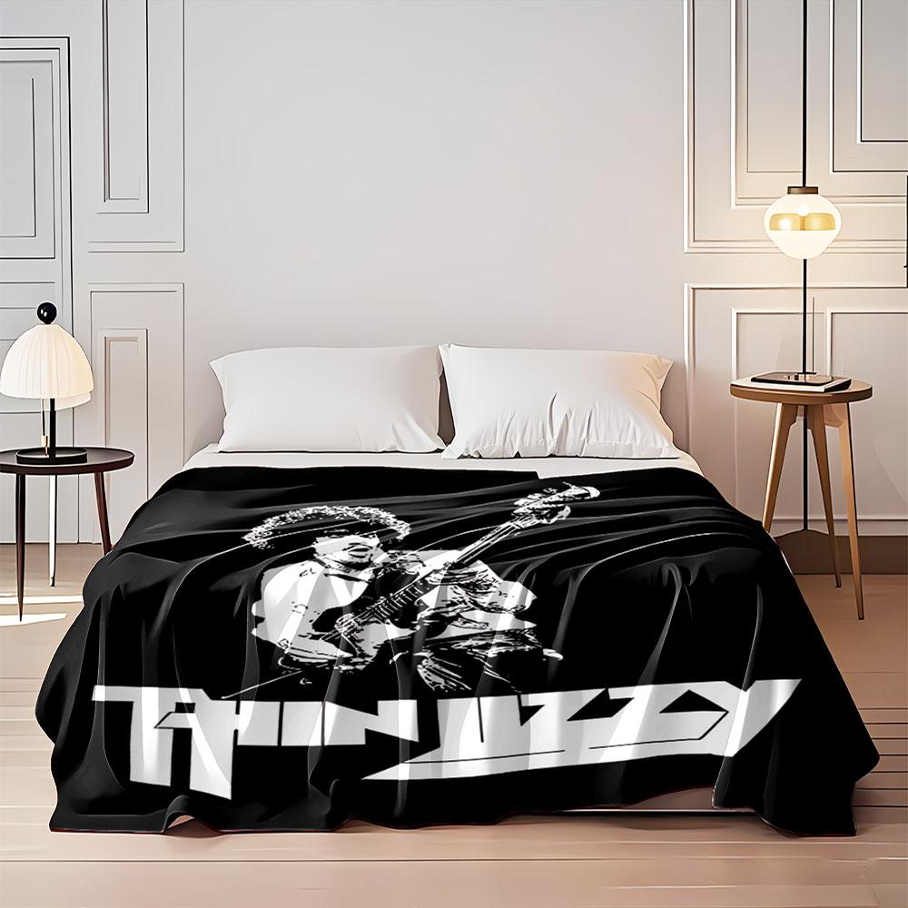 Stylized monochrome musician graphic with a bold "Thin Lizzy" logo. for all seasons blanket lunch break throw gift