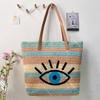 Large Woven Raffia Beach Bag With Eye Print Design And Dual Shoulder Straps For Vacation
