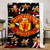 A Manchester United logo surrounded by gold stars on a red-black pattern. for all seasons blanket lunch break throw gift
