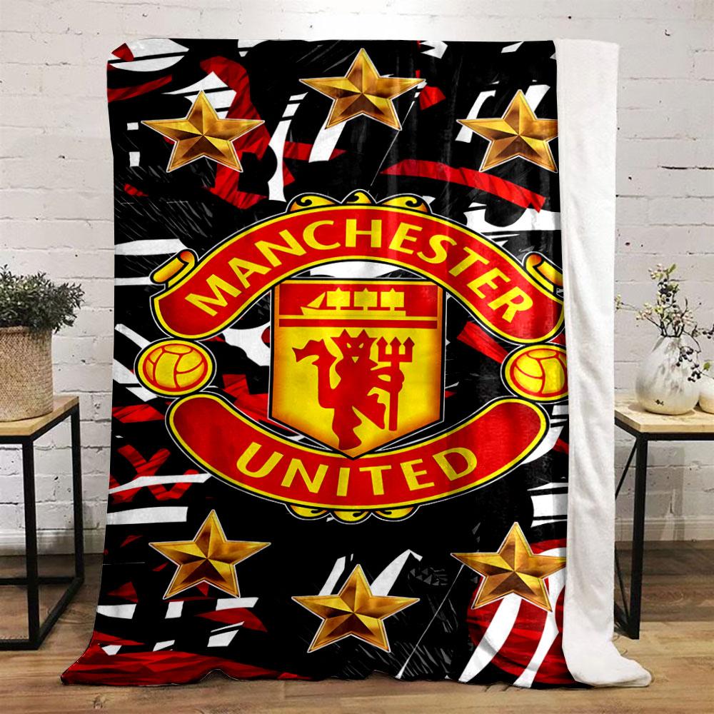 A Manchester United logo surrounded by gold stars on a red-black pattern. for all seasons blanket lunch break throw gift