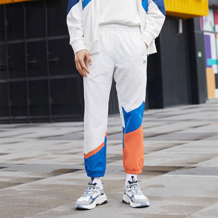 Li Ning Sports Fashion Series Logo Pattern Splicing Design Tapered Knit Pants Autumn Men Bottoms White AKXR421-3