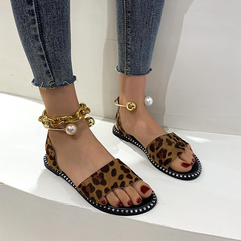 European and American one-word buckle flat sandals women's new open-toed simple pearl metal buckle cool slippers