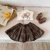 Осень/Зима 2025 Юбка в клетку плиссе в стиле колледжа для девочек - Универсальная трапециевидная модная юбка для малышей
