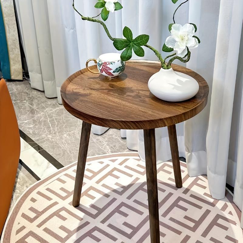 A Simple, Casual and Artistic Small Round Table Beside the Balcony Sofa, a Small Round Table and a Small Coffee Table