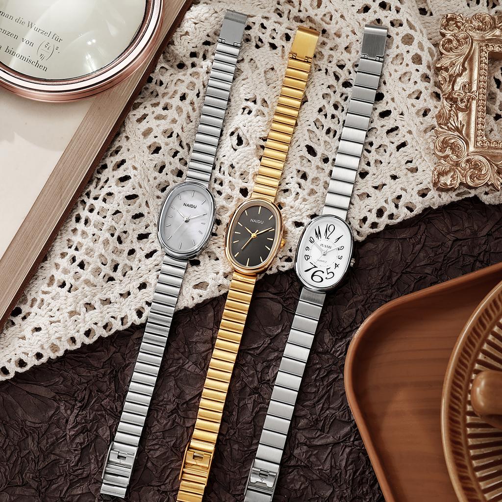 Женские изысканные и ценные кварцевые часы с овальным циферблатом со шкалой в виде арабских цифр, стальным ремешком в бамбуковом стиле.