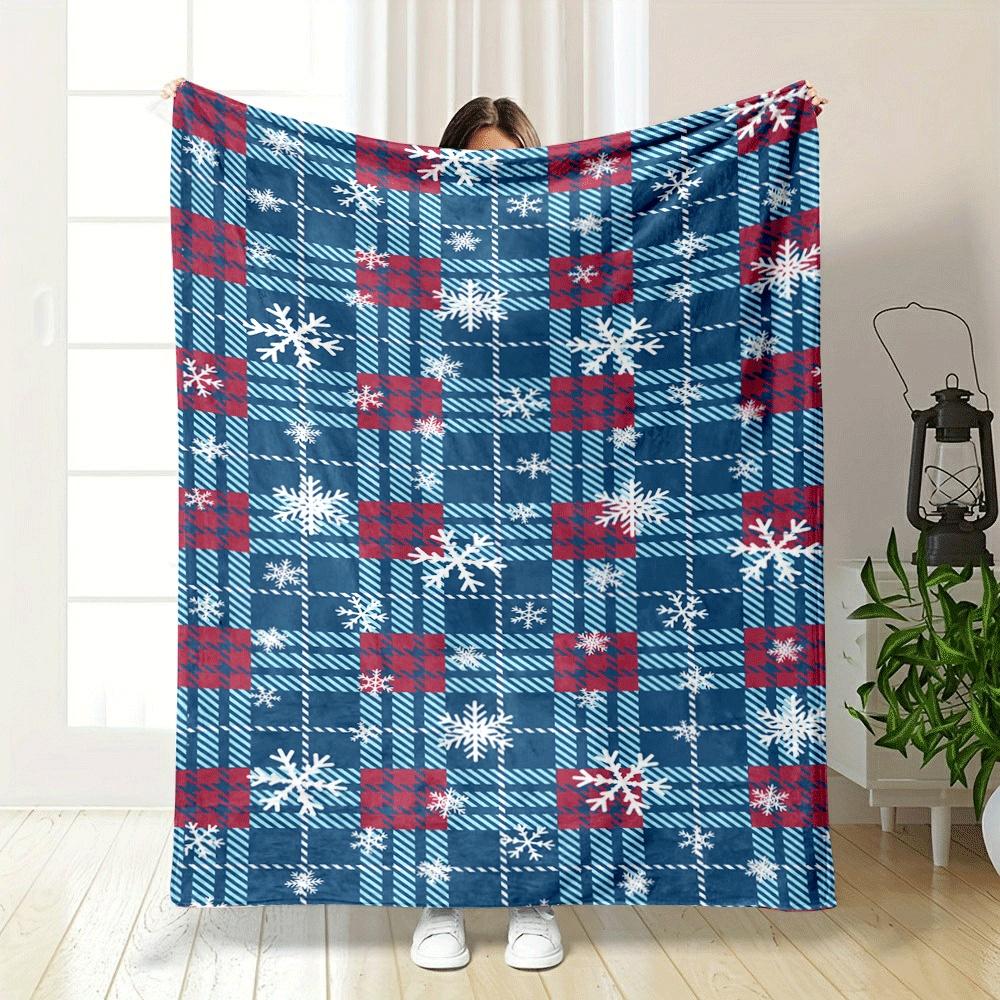 Plaid pattern in red, blue, and white with scattered white snowflakes. for all seasons blanket lunch break throw gift