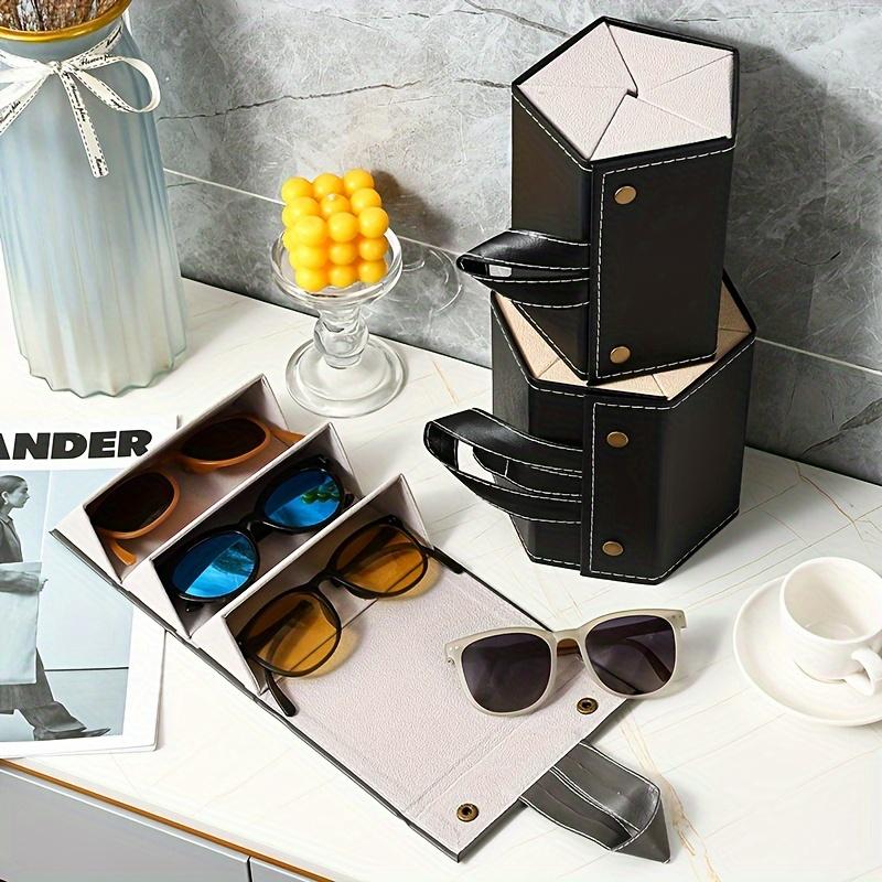 This sturdy faux leather foldable glasses case has snap closure and multi compartments Stylish black-white design, portable unisex eyewear storage box