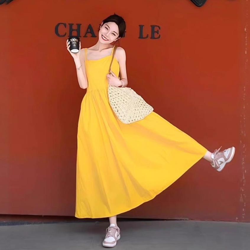 Women's yellow sleeveless dress, perfect for summer beach vacation photos; stylish maxi dress