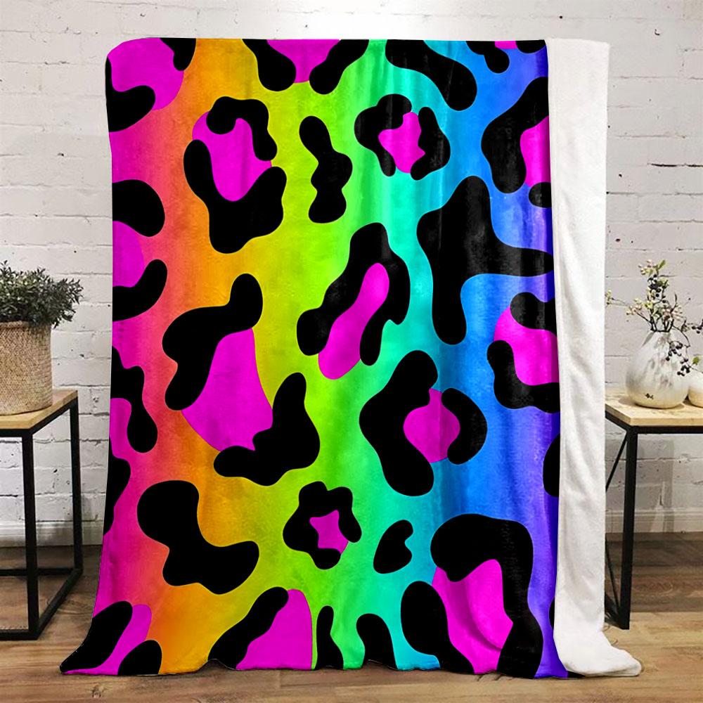 Leopard-like spots with black shapes on a vibrant rainbow gradient background. for all seasons blanket lunch break throw gift
