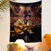 A performer in a gold jacket playing guitar on stage, with cheering crowd. Patterned tapestry for bedroom and living room home decor