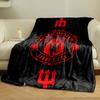A red Manchester United emblem with tridents on a black background. for all seasons blanket lunch break throw gift