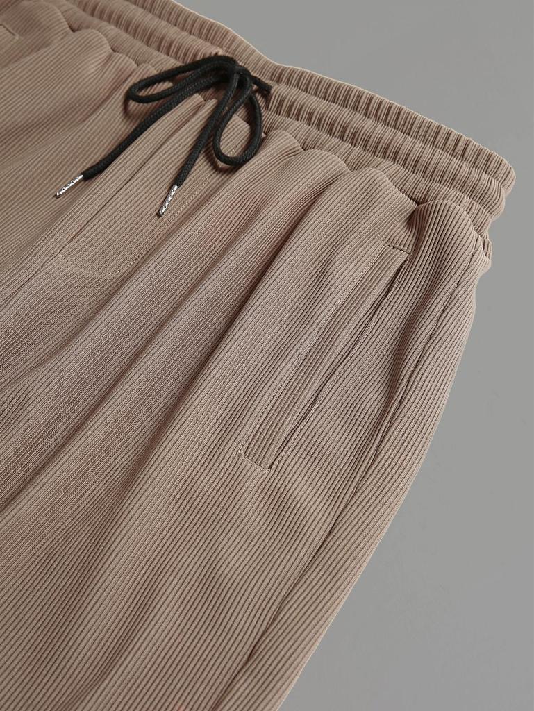 Мужской комплект: рубашка с воротником-стойкой, рубчатой жаккардовой вязки, на пуговицах спереди, с длинными рукавами, и брюки прямого кроя на кулиске.