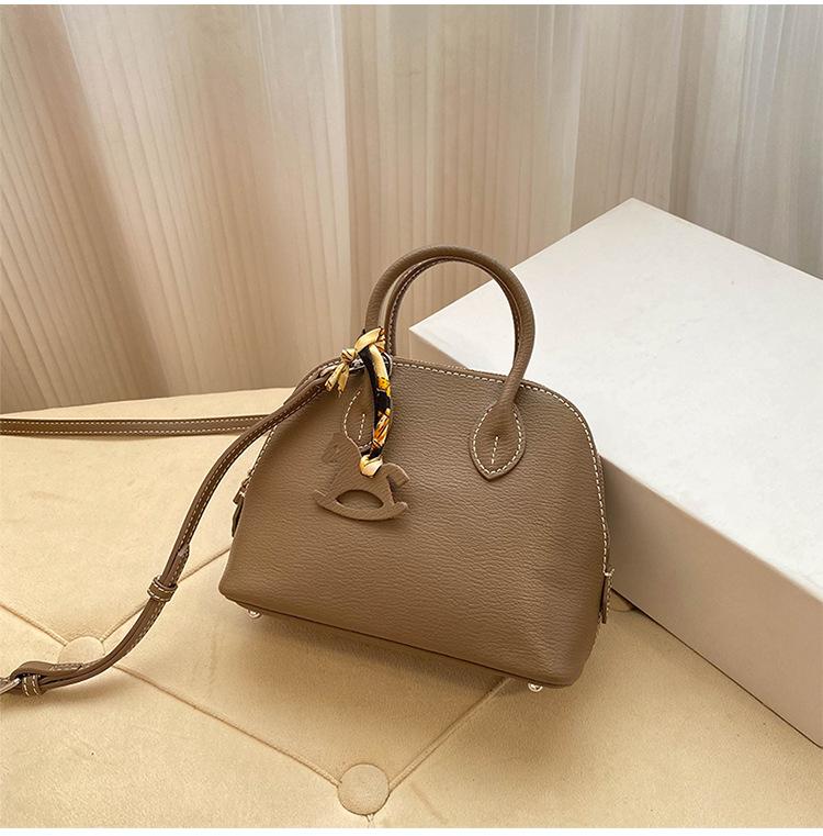 Премиальная мини-сумка-ракушка для женщин 2025 года, новая модная иностранная стильная изысканная сумка для переноски на одно плечо, диагональный пролет, воловья кожа, маленькая