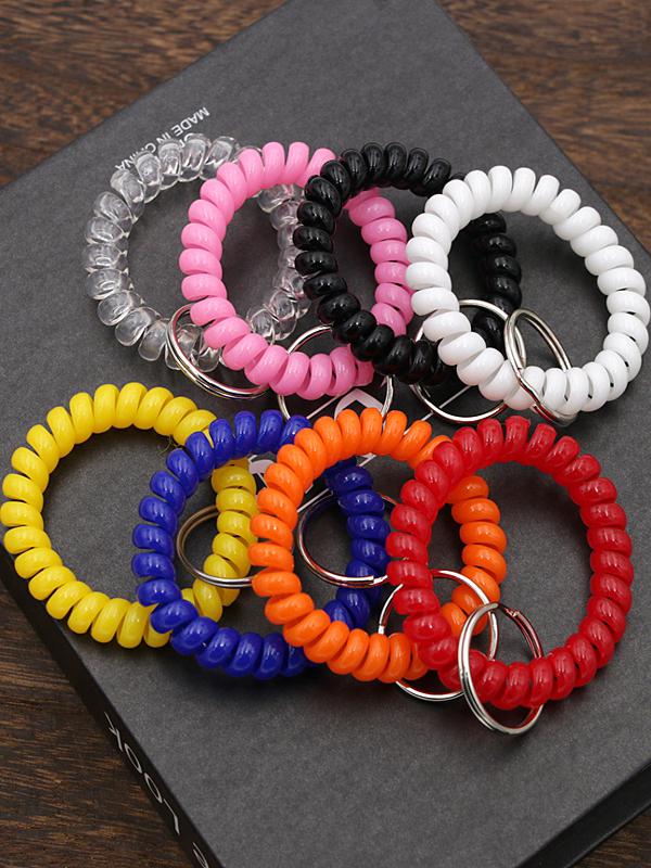 Минималистичный браслет-брелок и резинка для волос в виде пружинного механизма