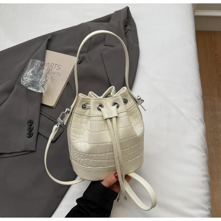 Модная женская сумка 2025 новая сумка-ведро через плечо в иностранном стиле с ремешком-помпой, нишевая сумка в стиле ретро с каменным узором