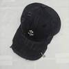 Trendy distressed baseball cap with a small iron badge, duckbill brim, and a paperclip pendant, fashionable for street style and making the face look