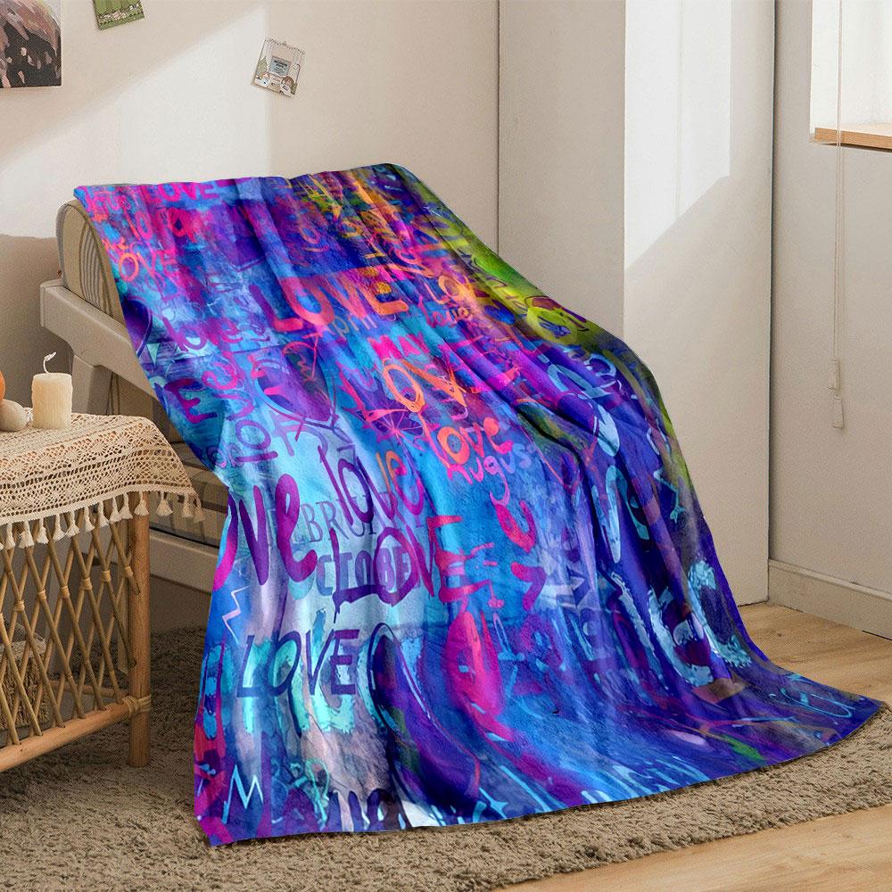 Multicolored "love" text and heart shapes layered on a vibrant background. for all seasons blanket lunch break throw gift