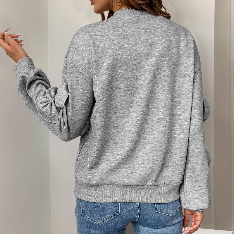A Sweet and Casual Autumn Woman In A Grey Round-neck Hoodie with A Bow and A Unique Style
