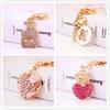 Elegant Diamond-Studded Four-Leaf Clover Keychain: Perfume Bottle Bag Charm for Women