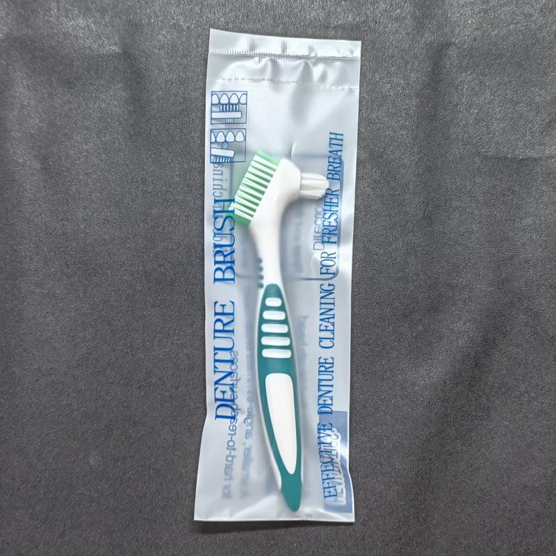 Красочная двусторонняя щетка для чистки зубных протезов - Предмет первой необходимости.