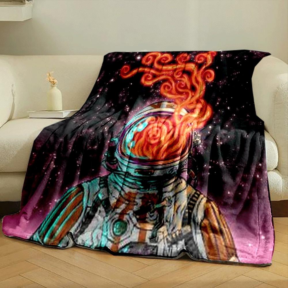 An astronaut's helmet emits swirling fiery patterns against a starry backdrop. for all seasons blanket lunch break throw gift
