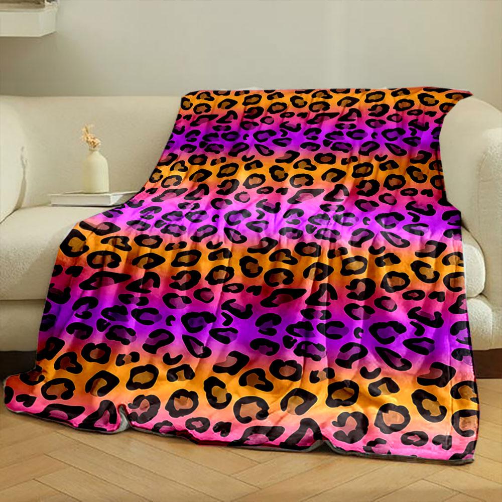 Black leopard spots on a gradient background of orange, pink, and purple. for all seasons blanket lunch break throw gift