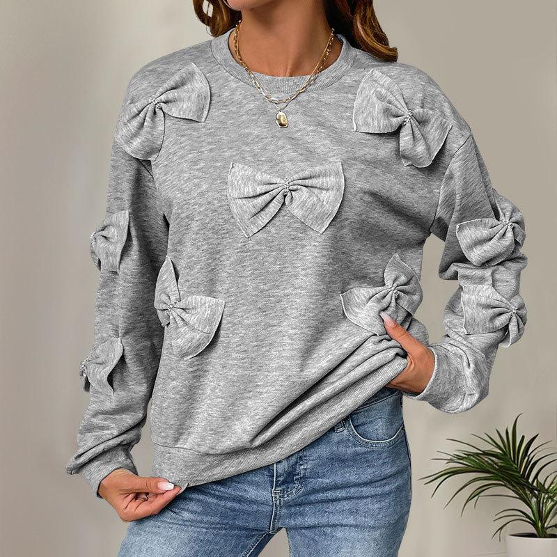 A Sweet and Casual Autumn Woman In A Grey Round-neck Hoodie with A Bow and A Unique Style