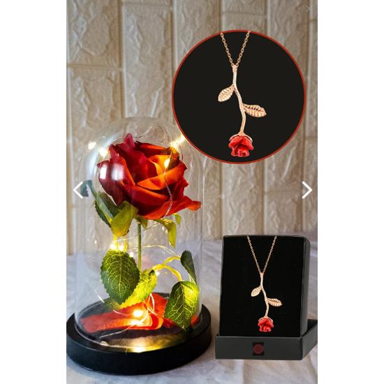 Фея привела освещенную неувядающую красную розовую лампу и подвеску с покрытием из розового золота в стеклянном куполе