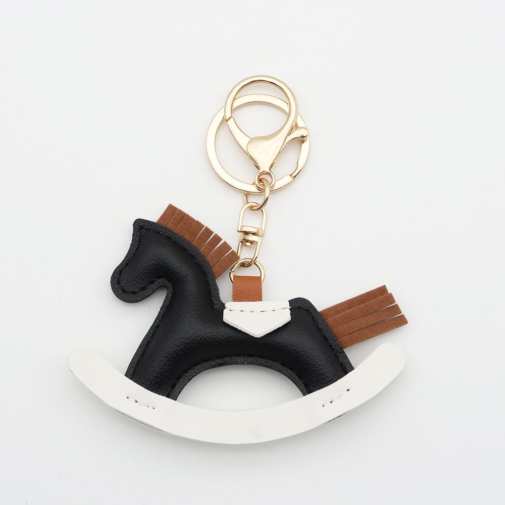Cartoon Rocking Horse Keychain: Creative PU Leather Pony Charm with Cotton Filling.