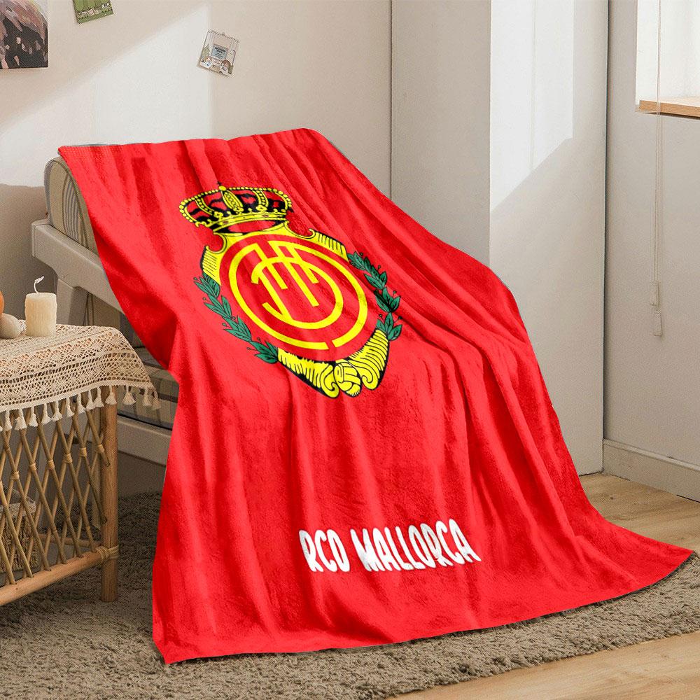 A crowned emblem with yellow circular patterns on a red background. for all seasons blanket lunch break throw gift