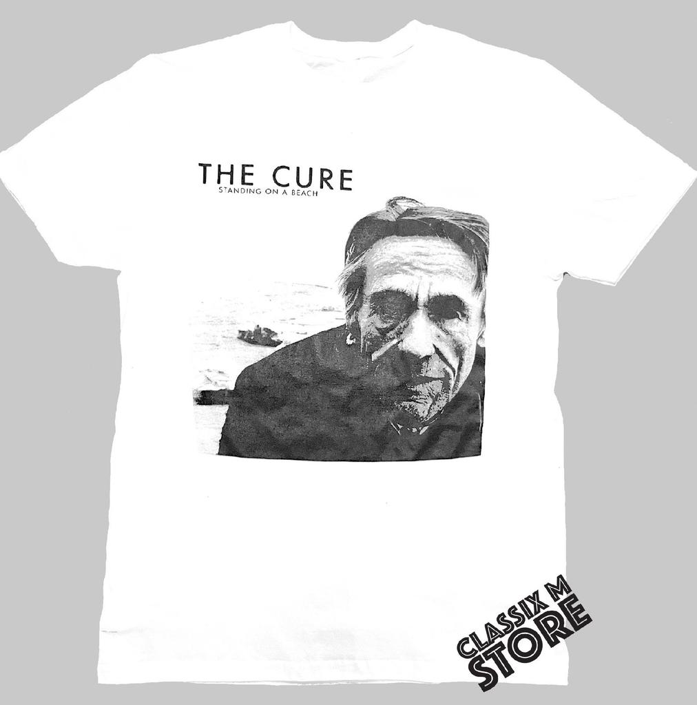 the cure standing on a beach
