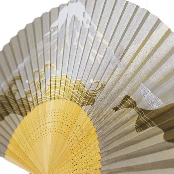 painted fan with featuring a design of Mount Fuji on a gold pearl High-quality fragrance, background.