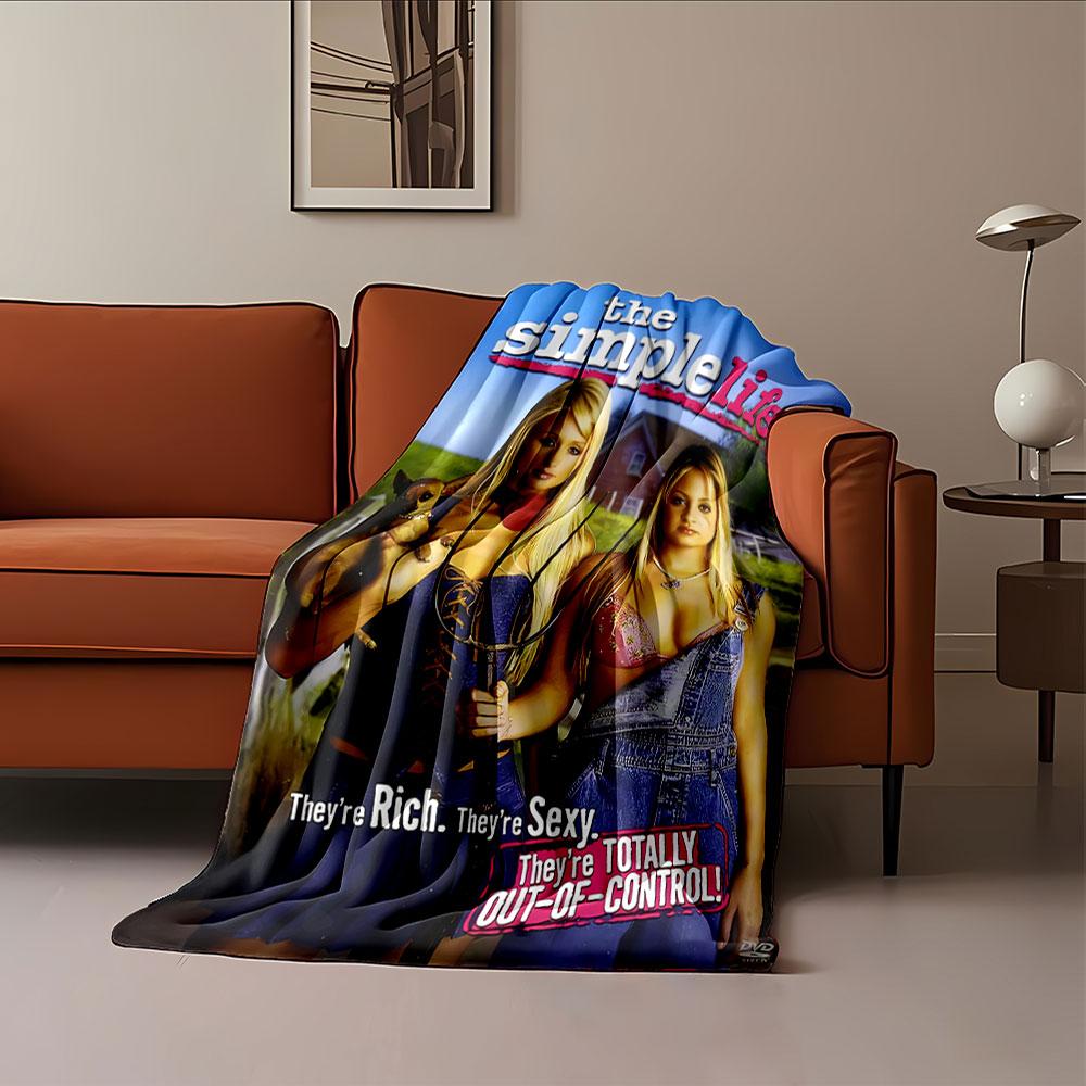 Two women dressed glamorously in a rural setting with bold text overlay. for all seasons blanket lunch break throw gift