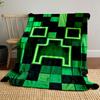 A pixelated green grid with a glowing, abstract face-shaped pattern. for all seasons blanket lunch break throw gift