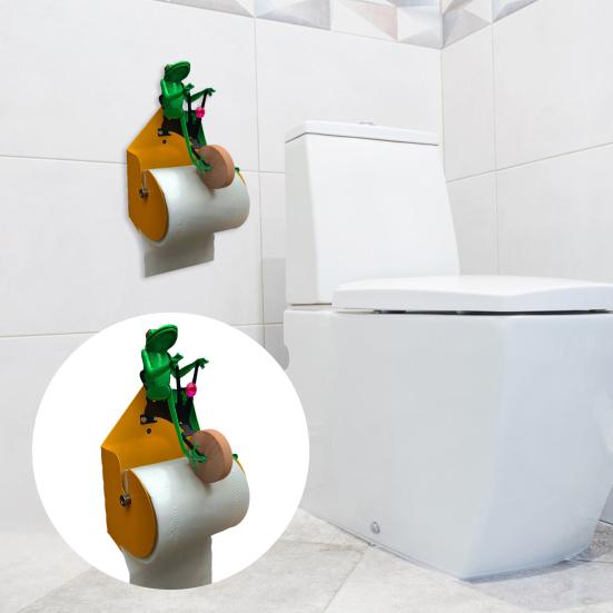 Держатель для туалетной бумаги. Милый дизайн в виде лягушки. Легко устанавливается. Лягушка, ездящая на одноколесном велосипеде. Стена.