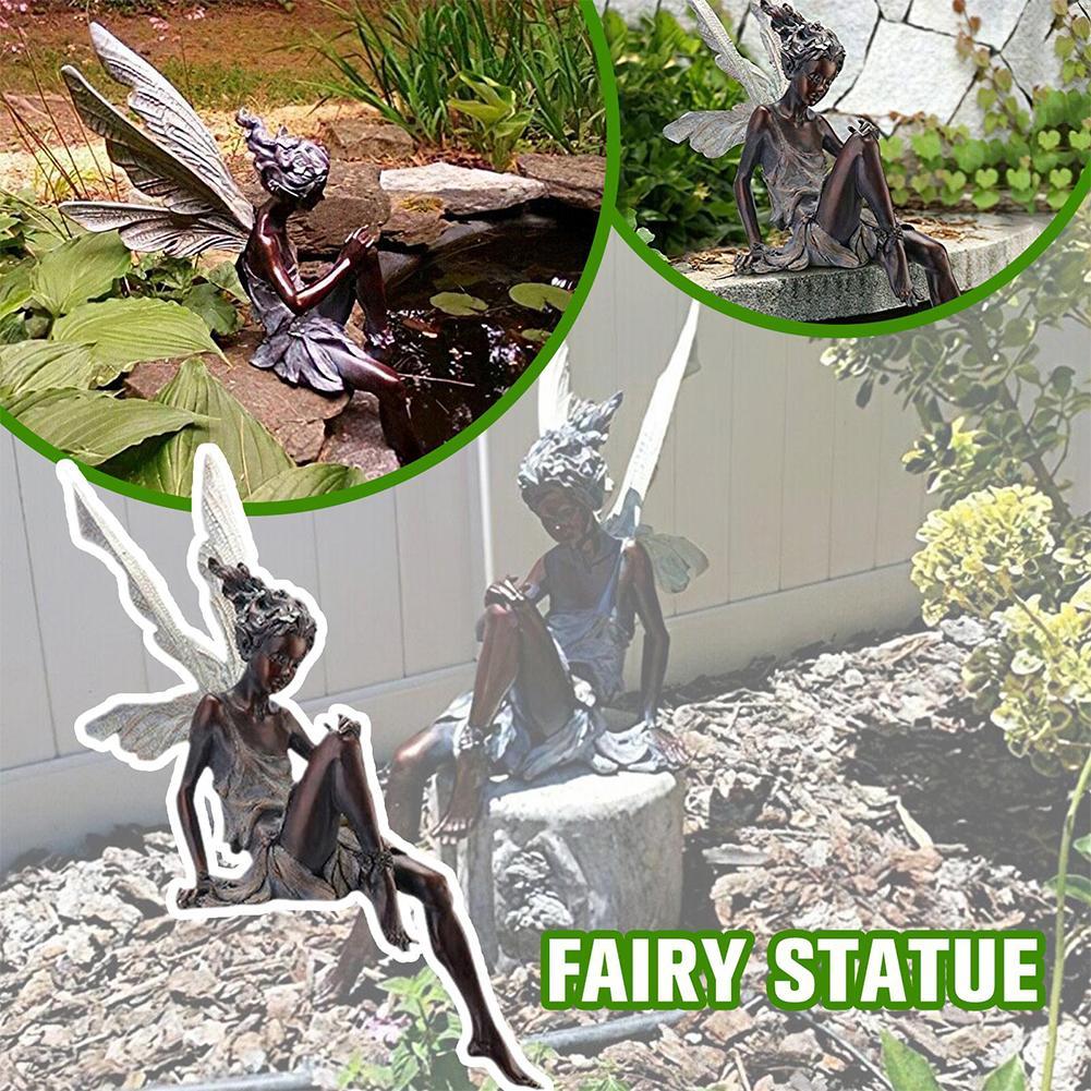 Statue of a seated angel with wings, garden decoration